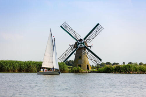a sailboat and a Dutch windmill